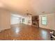 Spacious living room featuring a stone fireplace, neutral paint, and ample natural light at 1228 Reilly Ln, Clarkston, GA 30021