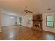 Spacious living room featuring a stone fireplace, neutral paint, and ample natural light at 1228 Reilly Ln, Clarkston, GA 30021