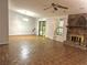 Spacious living room featuring a stone fireplace, neutral paint, and ample natural light at 1228 Reilly Ln, Clarkston, GA 30021