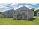 This backyard features green grass, a grey home and a covered patio at 13579 Whitman Ln, Covington, GA 30014