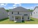 This backyard features green grass, a grey home and a covered patio at 13579 Whitman Ln, Covington, GA 30014