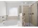 Clean bathroom featuring a separate tub and shower at 13579 Whitman Ln, Covington, GA 30014