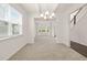 Bright dining room with a large window, modern chandelier and beautiful trim at 13579 Whitman Ln, Covington, GA 30014