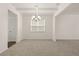 Open dining room with modern chandelier and view into the other rooms at 13579 Whitman Ln, Covington, GA 30014