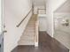 Bright entryway with hardwood floors, carpeted stairs, and an open floor plan at 13579 Whitman Ln, Covington, GA 30014