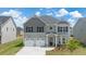 Beautiful two-story home with a two-car garage and a well-manicured lawn in a desirable neighborhood at 13579 Whitman Ln, Covington, GA 30014