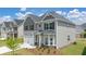 Charming two-story home with a three-car garage, neutral siding, and manicured lawn at 13579 Whitman Ln, Covington, GA 30014
