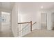 Upstairs hallway with access to bedrooms and bathrooms, featuring carpet flooring and neutral paint throughout at 13579 Whitman Ln, Covington, GA 30014