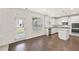 Open-concept kitchen and dining area features stainless steel appliances, granite countertops and hardwood floors at 13579 Whitman Ln, Covington, GA 30014