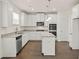 Beautiful kitchen with white cabinets, granite countertops, and stainless steel appliances at 13579 Whitman Ln, Covington, GA 30014