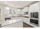 Modern kitchen with white cabinets, granite countertops, stainless steel appliances and a center island at 13579 Whitman Ln, Covington, GA 30014