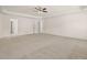 Spacious primary bedroom featuring tray ceiling, neutral carpet, and multiple entry points at 13579 Whitman Ln, Covington, GA 30014