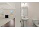 This bright powder room features a pedestal sink and connects to the living room at 13579 Whitman Ln, Covington, GA 30014