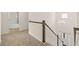 Elegant staircase with white railings and dark wood accents leading to the upper level and overlooking the entry at 13579 Whitman Ln, Covington, GA 30014