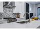 Close-up of a modern kitchen featuring stainless steel appliances, white cabinets, and stylish backsplash at 2323 Mason Dr # D21, Atlanta, GA 30316