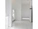 Bright bathroom with tiled floors, white cabinets and doors, and modern fixtures at 2718 Byess Ct, Marietta, GA 30064