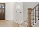 Bright foyer featuring a dark wooden door and staircase with modern black railings and light hardwood floors at 2718 Byess Ct, Marietta, GA 30064