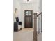 Bright foyer with a dark wooden front door, elegant decor, and a staircase with modern black railings at 2718 Byess Ct, Marietta, GA 30064