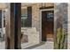 Inviting front porch featuring a stylish dark wooden door, brick facade, and tasteful outdoor seating at 2718 Byess Ct, Marietta, GA 30064