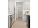 Bright kitchen with white cabinets, stainless steel appliances, and a view of the pantry at 2718 Byess Ct, Marietta, GA 30064