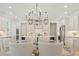 Open concept kitchen with white cabinets, stainless steel appliances, and an elegant chandelier over the island at 2718 Byess Ct, Marietta, GA 30064