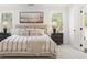 Bright main bedroom featuring a large bed, decorative pillows, and large windows at 2718 Byess Ct, Marietta, GA 30064