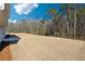 Large backyard featuring newly planted grass, ready for outdoor activities, and bordered by mature trees at 258 Orwell Dr, Social Circle, GA 30025