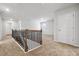 Upstairs hallway with carpet and access to multiple rooms; stairway in the background at 258 Orwell Dr, Social Circle, GA 30025