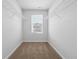Bright walk-in closet featuring carpet floors, white walls, and built-in wire shelving at 258 Orwell Dr, Social Circle, GA 30025