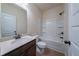 Bathroom with single sink vanity, shower-tub combination, and white door at 10 Edgewater Ct, Covington, GA 30016