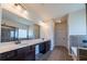 Modern bathroom featuring dual sinks, tile flooring, a shower, and great lighting at 10 Edgewater Ct, Covington, GA 30016