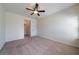 Spacious bedroom with neutral carpet, ceiling fan, window and access to other rooms at 10 Edgewater Ct, Covington, GA 30016