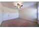 Bedroom featuring neutral carpet, ceiling fan, and natural light from the window at 10 Edgewater Ct, Covington, GA 30016