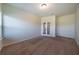 Carpeted bedroom showcasing natural light and decorative glass french doors at 10 Edgewater Ct, Covington, GA 30016