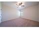 Cozy carpeted bedroom with a ceiling fan, window, and ample natural light at 10 Edgewater Ct, Covington, GA 30016