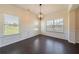 Stylish dining room with hardwood floors, decorative wall paneling, and modern lighting at 10 Edgewater Ct, Covington, GA 30016