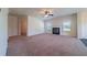 Large living room featuring a fireplace, plenty of natural light, and comfortable carpeting at 10 Edgewater Ct, Covington, GA 30016