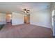 Spacious living room with plush carpeting and modern ceiling fan at 10 Edgewater Ct, Covington, GA 30016