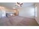 Spacious carpeted loft area with a ceiling fan, railing, and access to other rooms at 10 Edgewater Ct, Covington, GA 30016