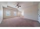 Expansive main bedroom with a tray ceiling, plush carpeting, and lots of natural light at 10 Edgewater Ct, Covington, GA 30016
