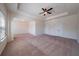 Large bedroom with a tray ceiling, ceiling fan, and double doors to closet at 10 Edgewater Ct, Covington, GA 30016