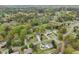 A wide aerial view shows lush, green residential neighborhood surrounded by dense trees on an overcast day at 106 Thornwood Dr, Woodstock, GA 30188