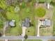 A picturesque aerial view displays the well-maintained lawns, driveways, and mature trees of three neighboring homes at 106 Thornwood Dr, Woodstock, GA 30188