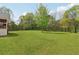 Expansive backyard featuring a well-manicured lawn with mature trees and a newly constructed back porch at 106 Thornwood Dr, Woodstock, GA 30188