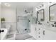 Bright bathroom featuring a double sink vanity, marble countertops, and sleek black fixtures in a modern design at 106 Thornwood Dr, Woodstock, GA 30188