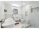 Beautiful bathroom with modern soaking tub, glass enclosed shower, and elegant fixtures at 106 Thornwood Dr, Woodstock, GA 30188