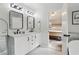Bathroom with double vanity and marble countertop next to a bedroom that has a neutral decor and light hardwood floors at 106 Thornwood Dr, Woodstock, GA 30188