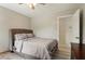 Comfortable bedroom with a plush grey bed and neutral décor, offering a peaceful and inviting space at 106 Thornwood Dr, Woodstock, GA 30188