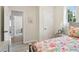 Comfortable bedroom with floral bedding, natural light and a hallway view at 106 Thornwood Dr, Woodstock, GA 30188