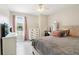 Bright bedroom with large window, grey floor, and a cozy reading corner, creating a relaxing and inviting atmosphere at 106 Thornwood Dr, Woodstock, GA 30188